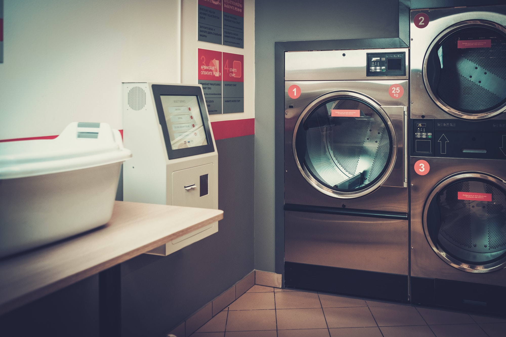 Laundry machines at laundromat shop.